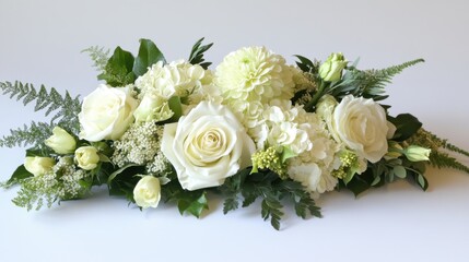A sophisticated white rose bouquet with gentle green accents, arranged neatly on a smooth white surface, ideal for text overlays.