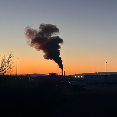 Obraz premium Industrial smoke rising at sunset On white background
