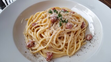 A plate of rich spaghetti carbonara, garnished with freshly grated parmesan and a sprinkle of cracked black pepper