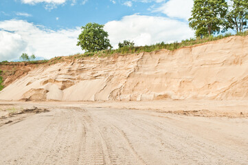 sand quarry against blue sky and trees