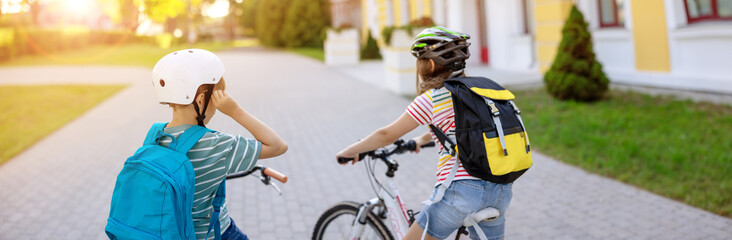 Fototapeta premium Boy and girl on the bicycles riding together.