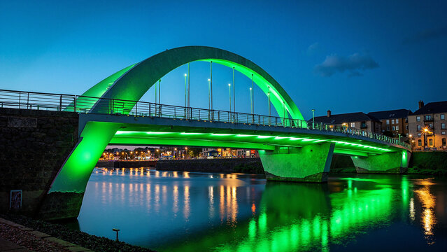 Modern Bridge Illuminated in Green for St. Patrick's Day in Waterford, Ireland: Perfect for Tourism Marketing