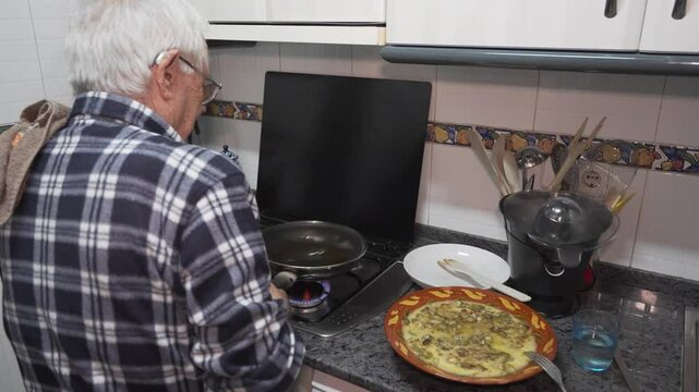 old man spinning vegetable omelette, eighty year old person in a checked shirt, living alone and cooking