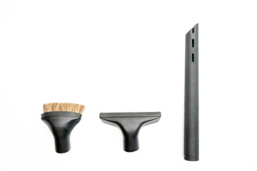 Black vacuum clearner hose attachments isolated on a white background.
