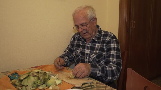 older man in the dining room cutting tortilla chips, plush plaid shirt, warm light