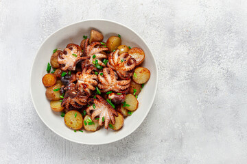 baby grilled octopus with golden baked potatoes and fresh herbs, Maltese cuisine, homemade, no people,