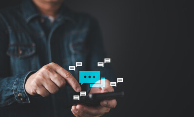 A person interacts with a smartphone, displaying chat bubbles, symbolizing digital communication and messaging.
