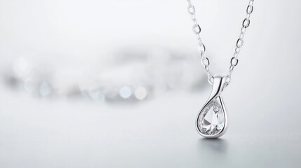 Elegant Silver Necklace with Pear-Shaped Crystal Pendant on Light Background