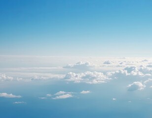 Fototapeta premium Serene blue sky with soft white clouds, creating a tranquil aerial view.