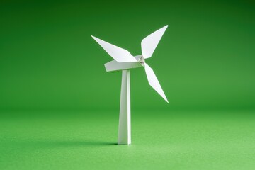 Green innovation and sustainable energy. Paper wind turbine model against a green backdrop.