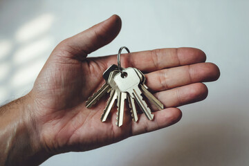 Bunch of keys to an apartment in a hand.