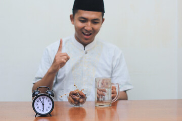 Asian muslim men look happy when the time of adhan has resounded to break the fast.