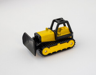 Yellow and Black Toy Bulldozer with Tracks on White Background