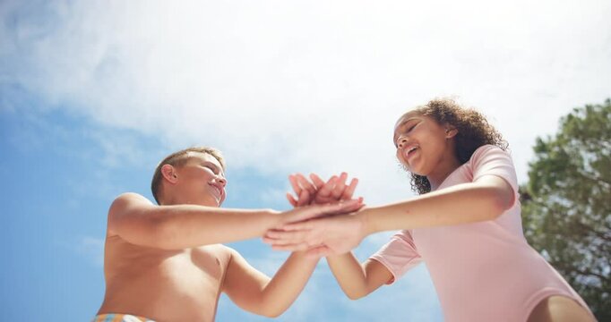 Below, children and handstack with smile outdoor for silly game, playful and bonding of summer vacation. Excited, kids and sky with activity for family unity, celebration and fun agreement on holiday