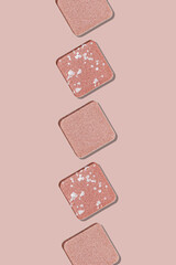 Swatches eyeshadow refills as minimal background. Monochrome Matte, glitter pans pale pink shade in row, detailed texture, sunlight, minimal trend cosmetics vertical photo, beauty product, eye makeup