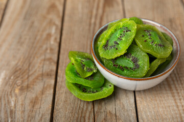 Kiwi dried fruit on wooden background. kiwi candied fruit. Healthy food. Ingredient for baking...