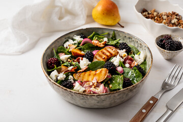 Grilled pear salad, Fresh salad with pears, spinach, cheese, walnuts, blackberries and dressing