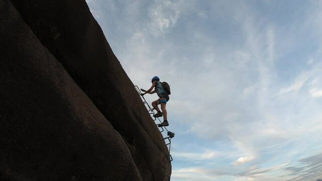 Attached to Via Ferrata Picasass, the climber makes the final stretch on the iron path up a sheer cliff, near Lago Maggiore.