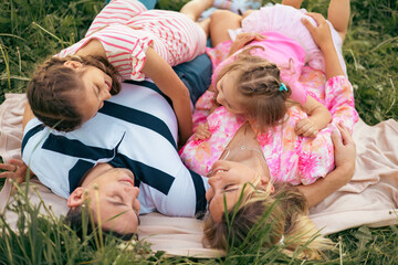 Happy Family Lying Together on a Picnic Blanket