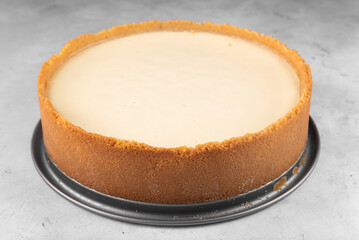 New York cheesecake on a plate on a gray background