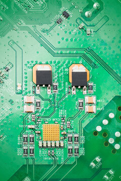 Close up of green circuit board with chips electronic and components