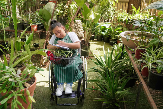 Disabled woman working at plant nursery