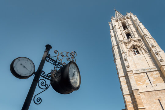 Clock and tower of Santa Maria de Regla de Leon Cathedral under blue sky