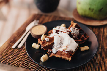 Tasty chocolate dessert with waffle served on bamboo mat