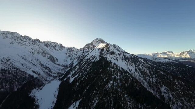 A stunning view of Champex Lac in the Swiss Alps at dusk, with snow-covered peaks, serene winter landscape, and a peaceful alpine setting under the fading light.