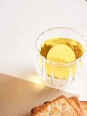 Composition with a cup of tea and crackers on white background. Top view. Aesthetic cozy concept.