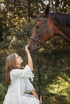 Tender Moment Between Young girl and Horse in Nature