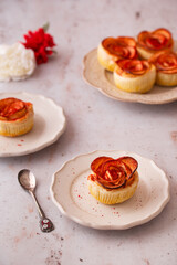 Apple roses Puff pastry sprinkled with red dry powdered strawberry. Romantic Dessert for Valentine's Day or Birthday. Twisted cake. Food photography and styling.