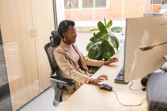 Professional office setting with focused employee at desk