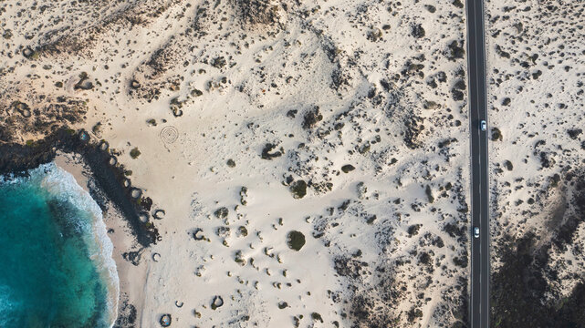 Aerial view of a rural road beside the beach in Caleton Blanco Beach, Lanzarote