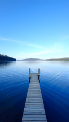 Fototapeta premium Perfect water view pier. Waterfront lake with small pier, Dreamy. with white shades