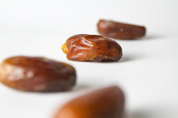 Date fruit, kurma Tunisia on small bowl on isolated white background.