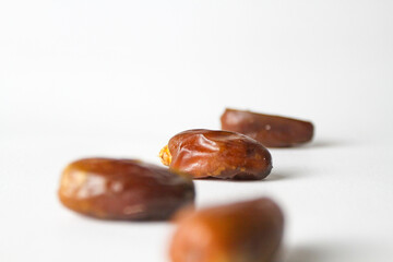 Date fruit, kurma Tunisia on small bowl on isolated white background.