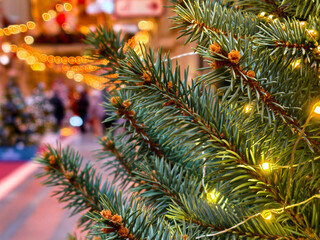 Sparkling holiday cheer realized through glimmering lights on elegantly adorned Christmas tree decorations in a festive setting