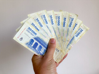 hand holds new 20.000 Argentine peso bills of Central Bank of the Argentine Republic