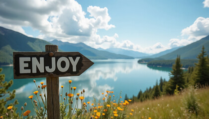 Obraz premium Enjoy signboard overlooking a tranquil lake surrounded by mountains and flowers for countryside traveling concept, copy space
