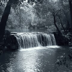 Fototapeta premium Serene Monochrome Waterfall Surrounded by Lush Trees and Tranquil Nature in a Peaceful Setting