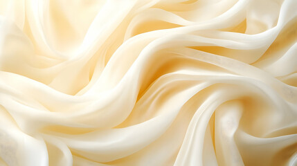 Obraz premium Elegant, flowing cream fabric with soft folds, perfect for backgrounds, textile design, or fashion projects.