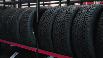 Close-up of car tires on shelves in auto parts store