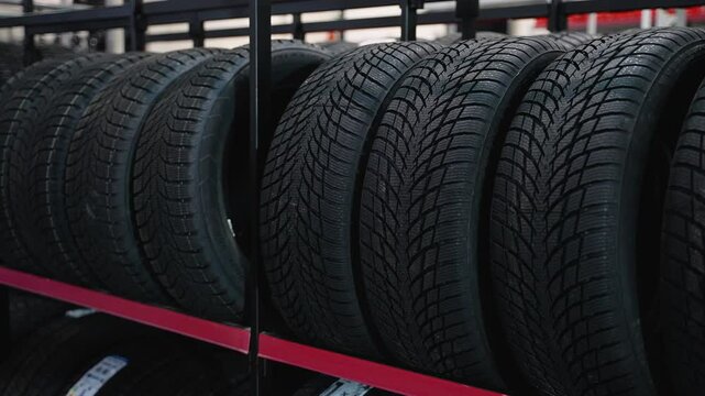 Close-up of car tires on shelves in auto parts store