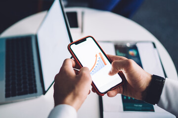 Crop man using gadgets in office