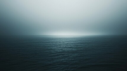 Obraz premium Serene Ocean View Under Foggy Sky with Calm Water Reflections