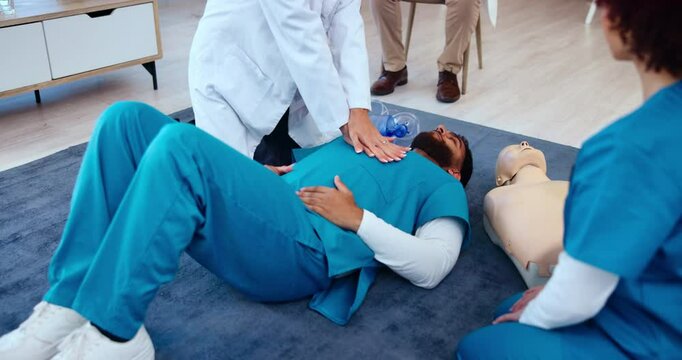 Training, cpr workshop and man for learning, doctor or breathe check practical. Paramedic, people or open airway with employees in class for emergency, healthcare or career development with technique