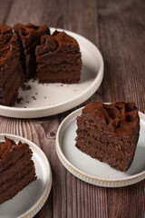 Indulgent Chocolate Cake Slice on Rustic Plate, Perfect for Dessert Lovers Seeking Rich and Decadent Chocolate Flavor, Ideal for Celebrations and Casual Enjoyment
