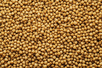 Roasted chickpeas arranged in a vibrant pile with spices on a bright background