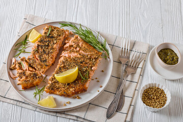 baked salmon fillet with lemon, rosemary on plate